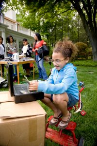 Girl counting money at yard sale